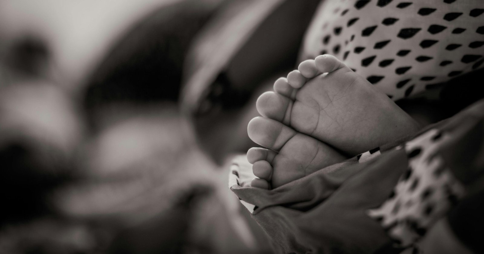 A serene black and white image of infant feet, depicting tranquility and innocence.